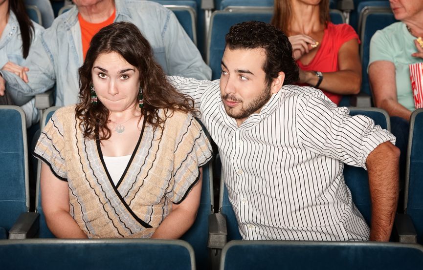 a shy woman sitting beside a guy