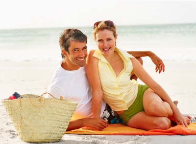 Mature couple taking a photo on the beach