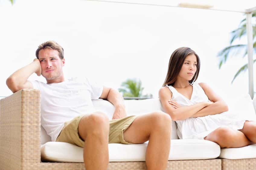 couple sitting on the couch ignoring each other