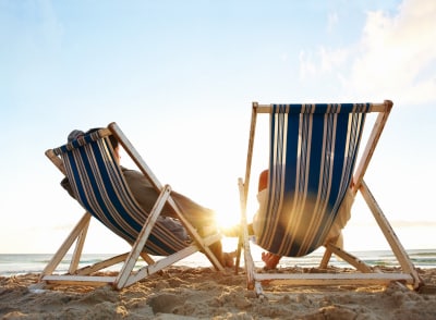 Image of a tired young couple resting on the beach