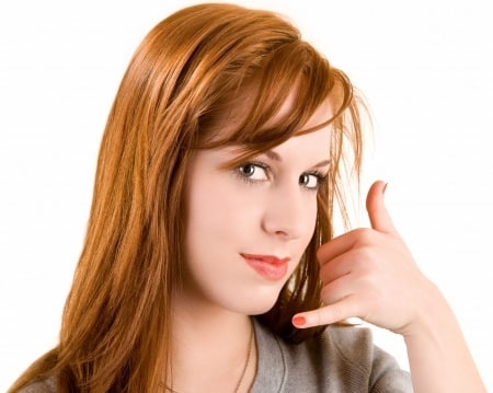 Red haired woman doing a calling pose