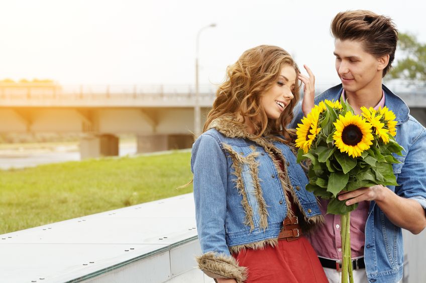 man giving sunflowers to a beautiful woman on their first date