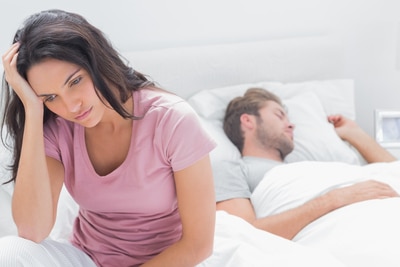 anxious woman in bed dating a new guy