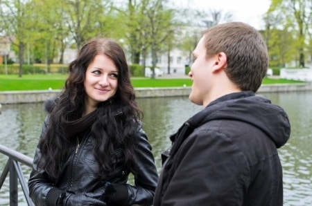 Man and woman talking by the pond