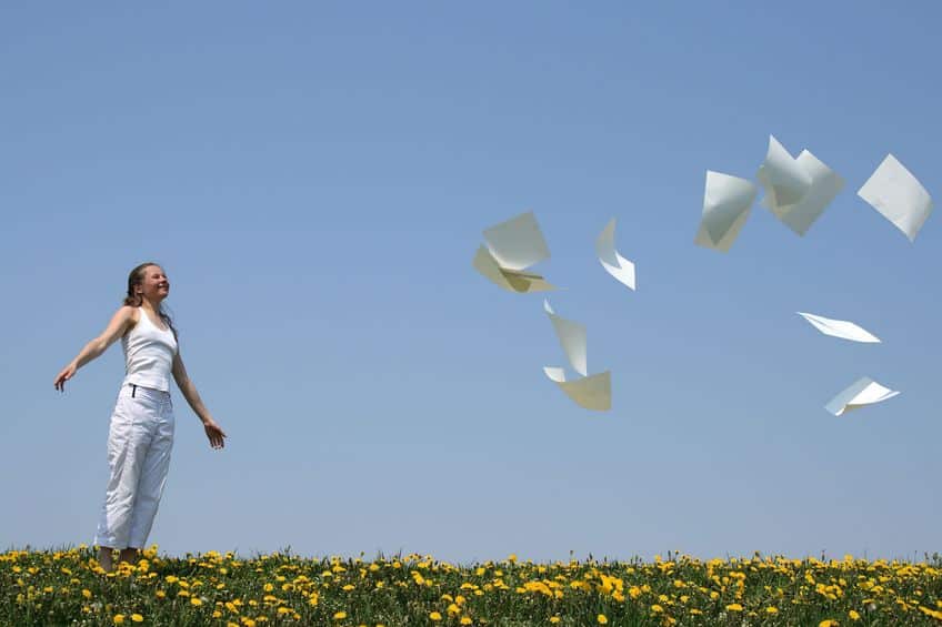 a girl tossing papers