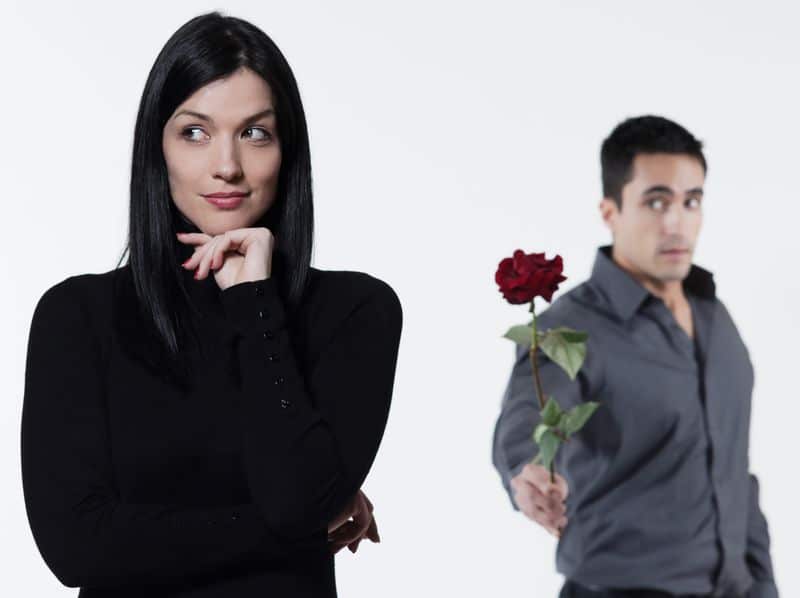 A man giving flower to a woman