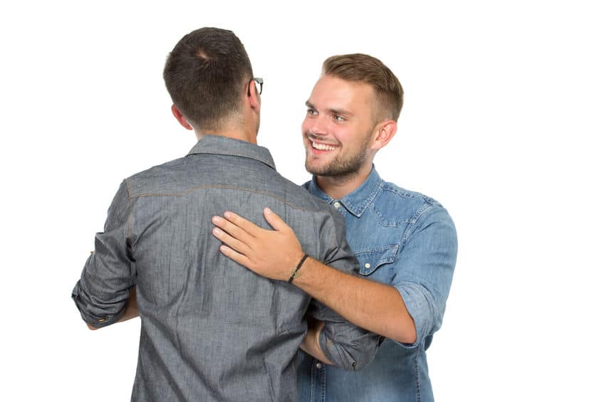 two men hugging each other