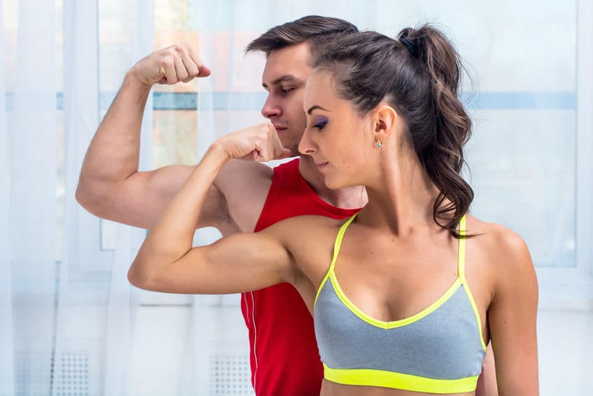 couple showing off their arm muscles