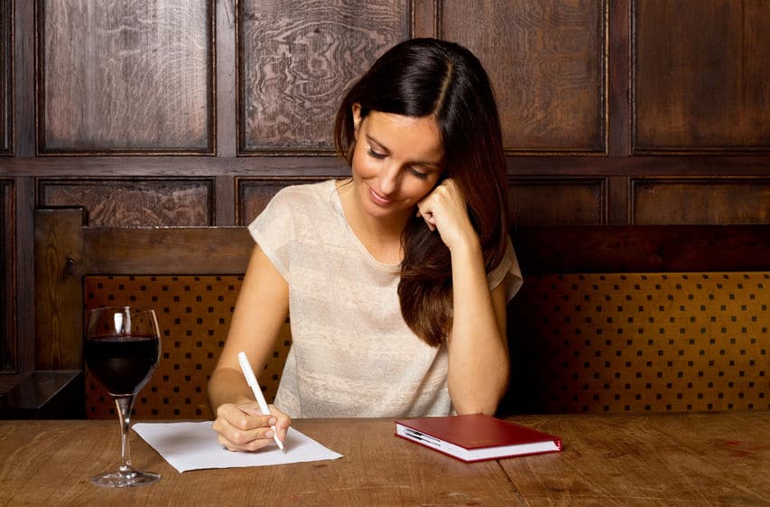 woman writing a checklist