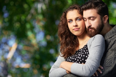 man embracing his woman from behind