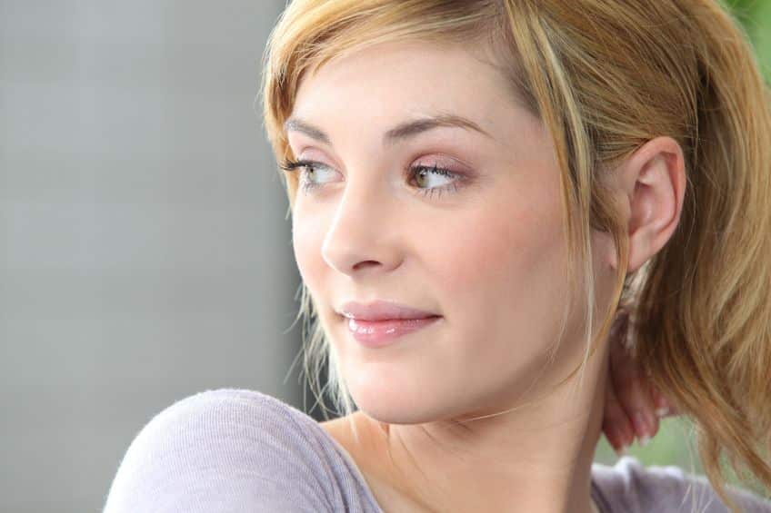 young blonde woman looking at her side