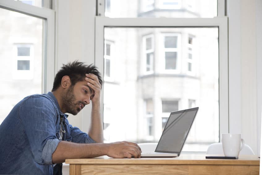 a frustrated guy staring at his laptop