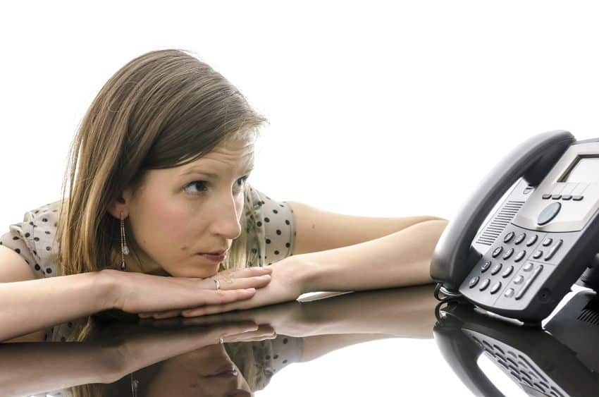 woman looking intently at the telephone