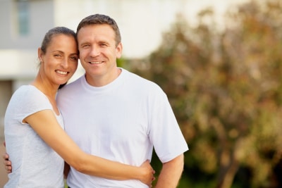 Smiling mature couple standing together outdoors