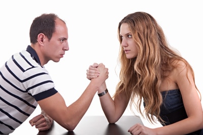 a man and a woman arm-wrestling