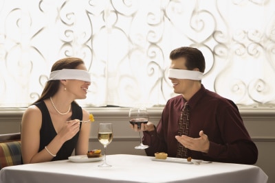 young adults having a restaurant date, blindfolded