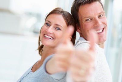 young confident couple thumbs up