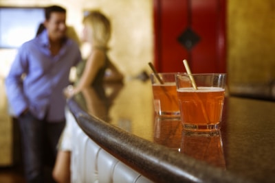 man and woman talking at the bar