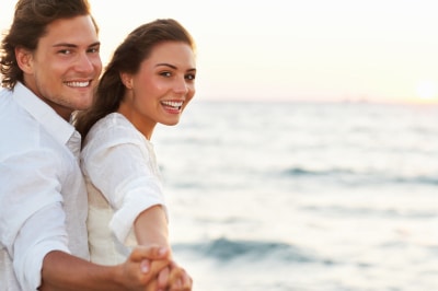 young couple at the beach during sunset