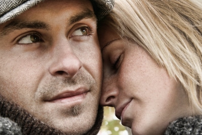 woman's forehead on man's cheeks