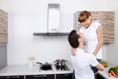 husband lifting his wife at the kitchen