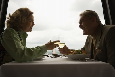 mature couple at a restaurant drinking wine and laughing