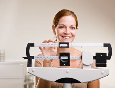 conscious woman checking her weight
