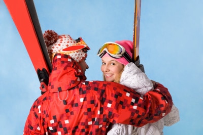 happy female being embraced by sporty man