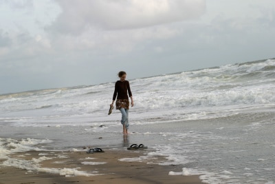 woman walking on the shore, alone