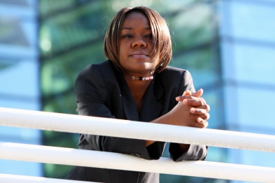 black woman standing, hands clutched