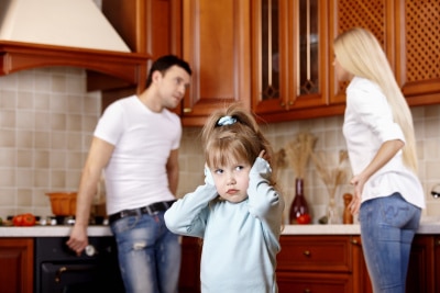 young couple fighting in front of their kid