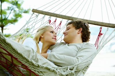 a long-termed couple laying on a hammock