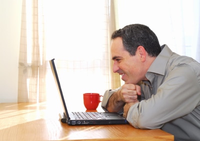 man looking at sexy photos of his girlfriend