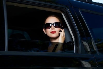 a smart, strong, successful woman on a black car