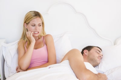 woman examining her boyfriend while sleeping