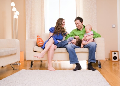 Happy young family of four enjoying time at their home