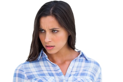 Angry brunette looking at camera on white background