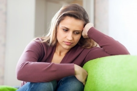 lonely woman thinking on a couch