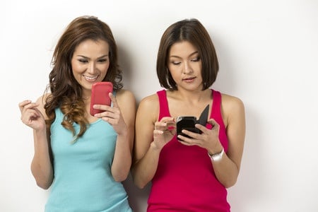 two pretty girls using dating apps