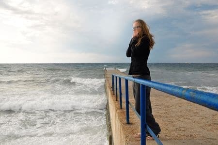 lonely woman thinking while staring at the beach