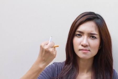 woman holding a cigarette on her hands