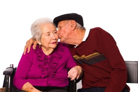 happy old man kissing his old wife