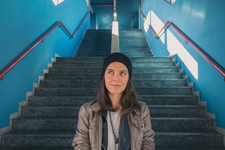 woman walking down the stairs thinking about having deep intimate conversations on a date