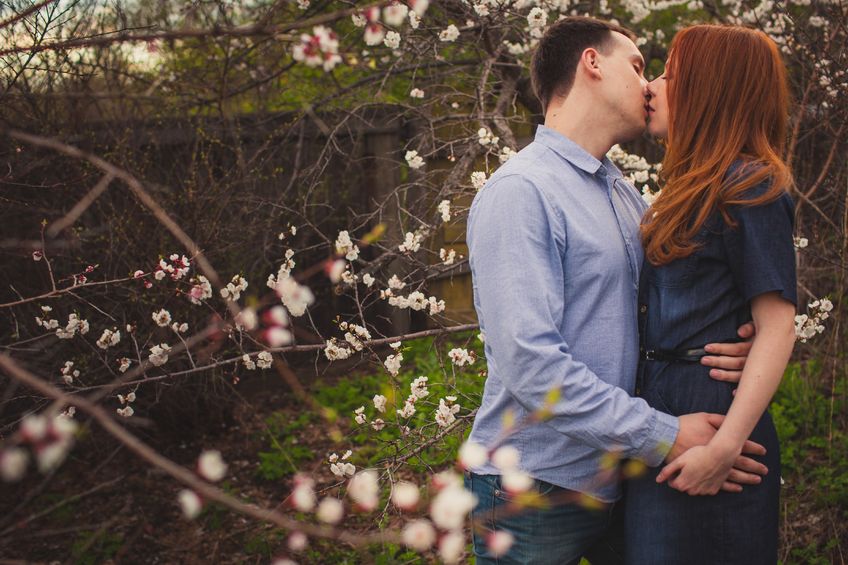 young sweet couple kissing in the garden