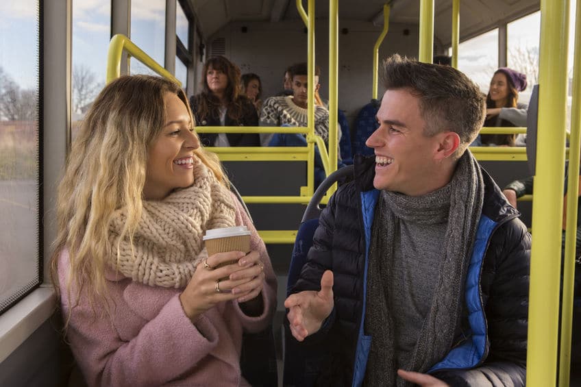 man and woman having a small talk on the bus