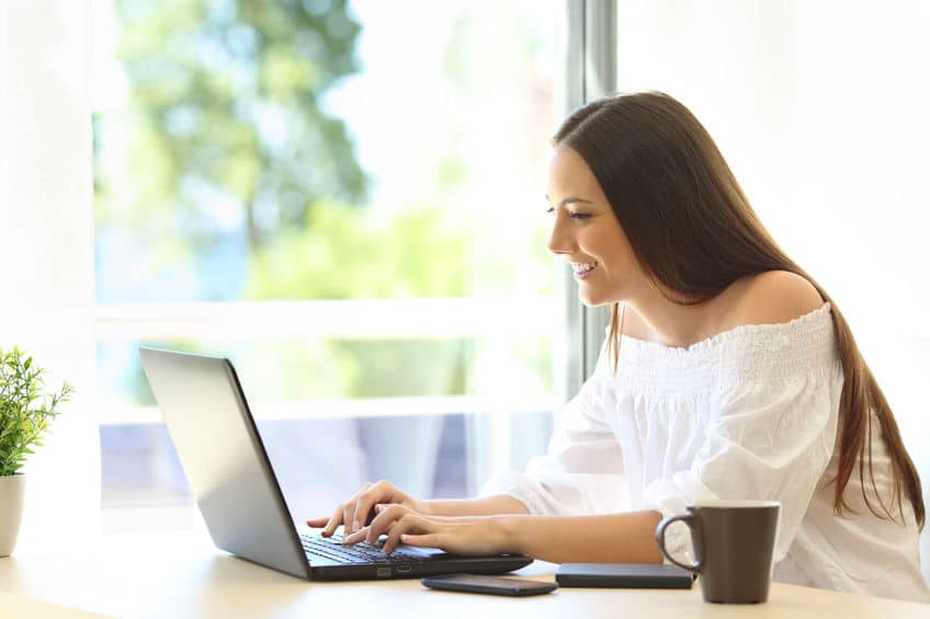 woman writing a perfect profile on her laptop