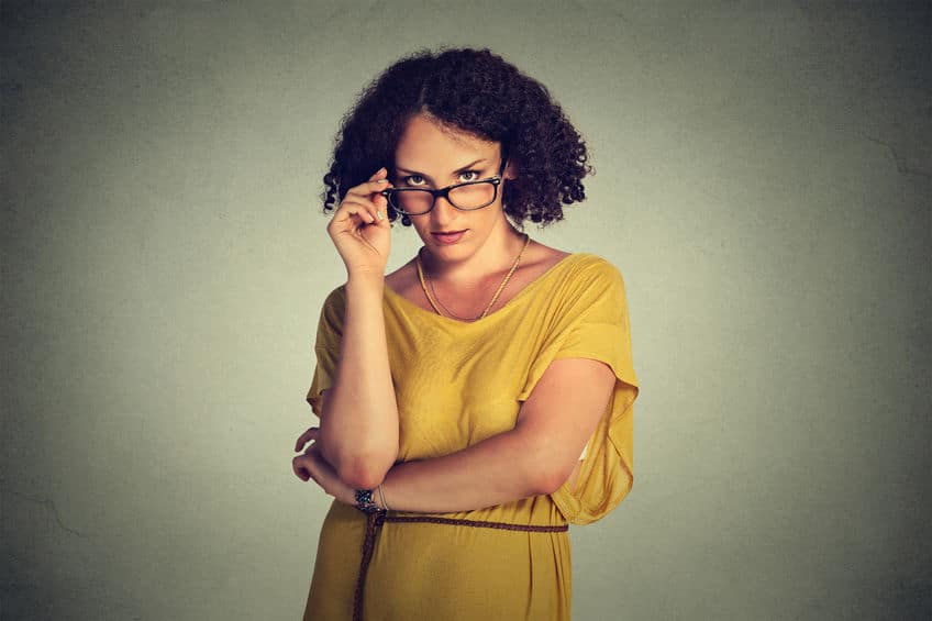 feminist woman wearing eyeglasses and yellow dress