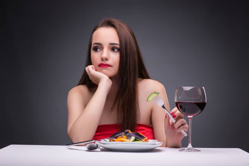 lady in red eating and drinking wine