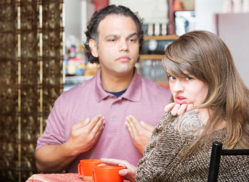 woman with tattoo having a coffee with boyfriend