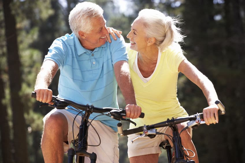 happy matured couple biking